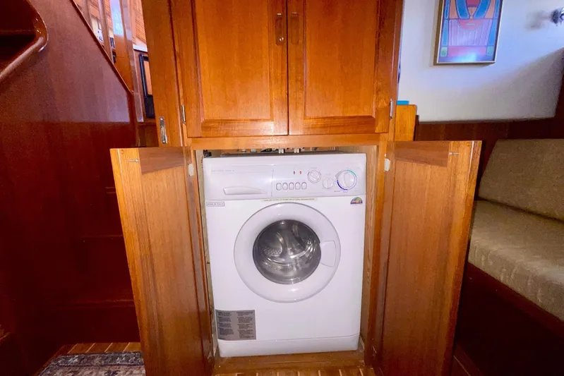 Slainte II Yacht Photos Pics Washer in wooden cabinet aboard 2008 Nordic Tug 42 boat interior.