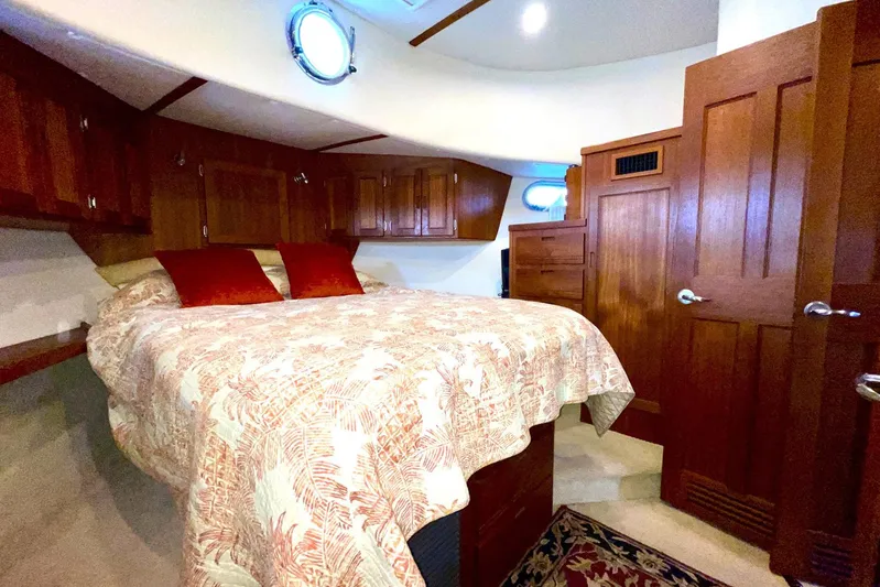 Slainte II Yacht Photos Pics Luxurious 2008 Nordic Tug 42 bedroom with wood cabinetry and cozy bedding.