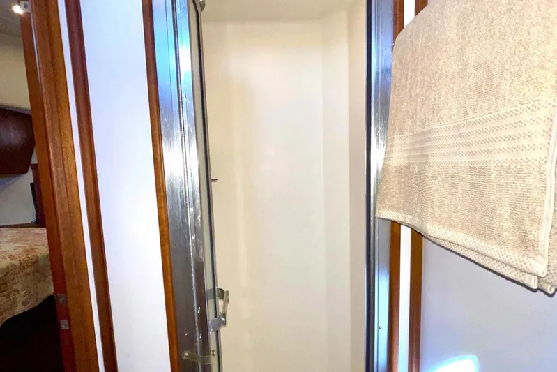 Slainte II Yacht Photos Pics Shower area inside 2008 Nordic Tug 42 boat, featuring wooden trim and towel rack.