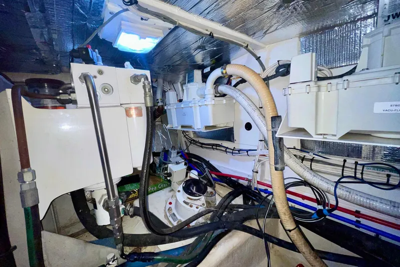 Slainte II Yacht Photos Pics Engine room of 2008 Nordic Tug 42 with various mechanical components and wiring.