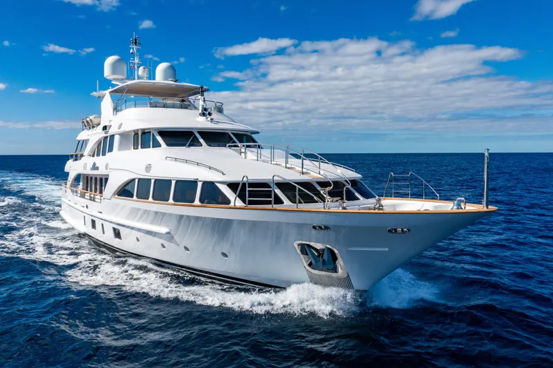 Allora Yacht Photos Pics Luxurious 2011 Benetti Classic 121 yacht cruising on open sea under clear blue sky.