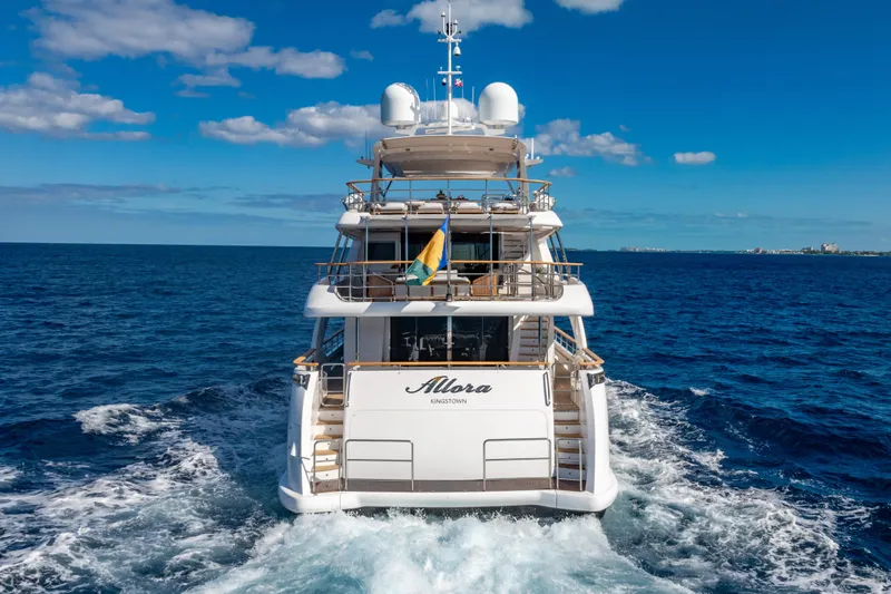 Allora Yacht Photos Pics Benetti Classic 121 yacht cruising on open sea, 2011 model, under clear blue sky.