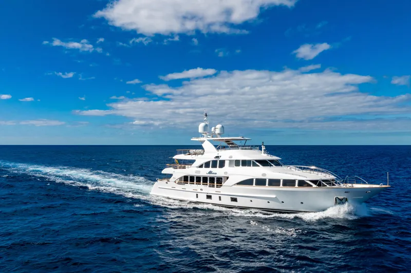 Allora Yacht Photos Pics Luxurious 2011 Benetti Classic 121 yacht cruising on open sea under clear blue sky.