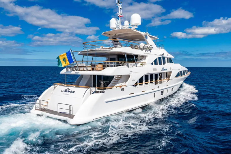 Allora Yacht Photos Pics Luxurious 2011 Benetti Classic 121 yacht cruising on open sea under clear blue skies.