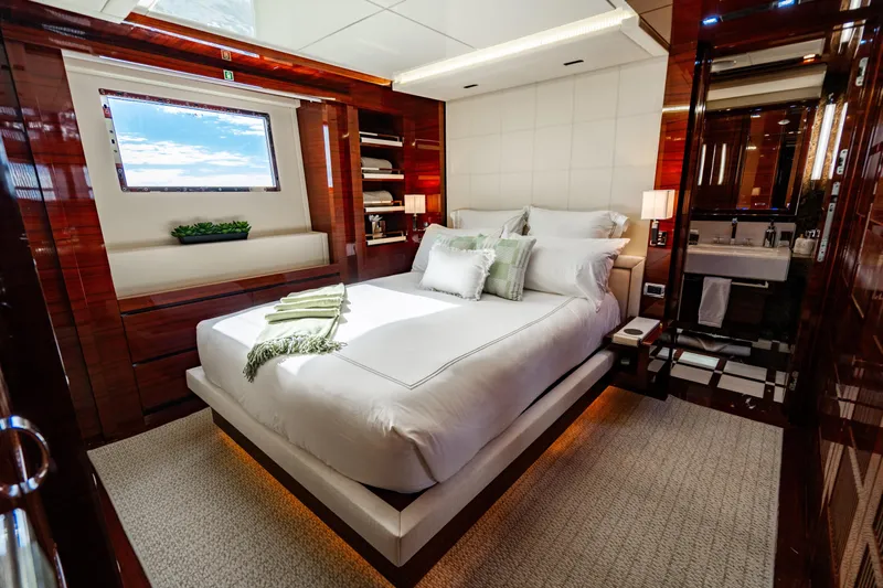 Allora Yacht Photos Pics Luxurious bedroom interior of 2011 Benetti Classic 121 yacht with elegant decor and ocean view.