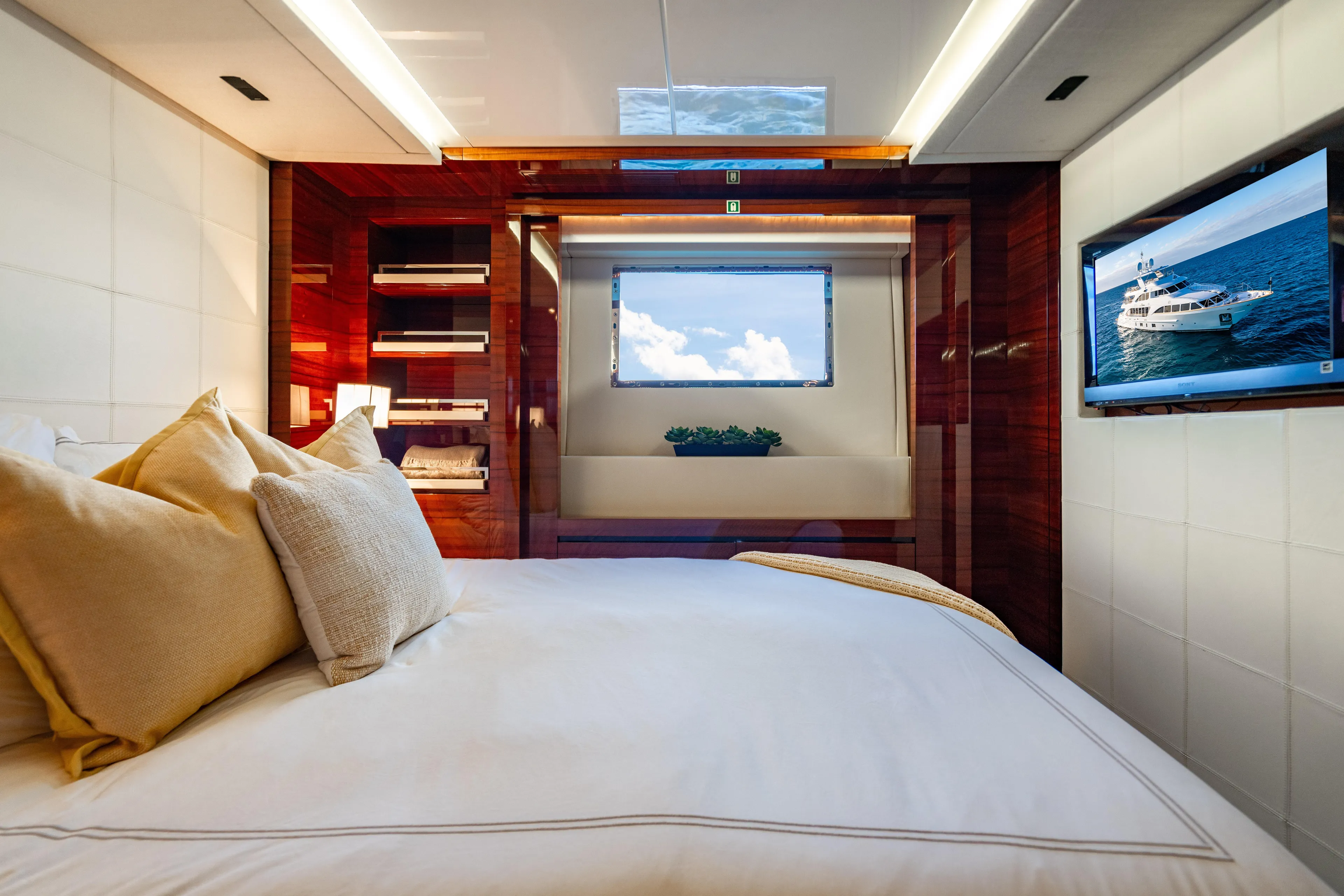 Allora Yacht Photos Pics Luxurious bedroom interior on 2011 Benetti Classic 121 yacht, featuring elegant decor and ocean view.