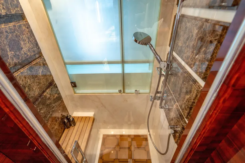 Allora Yacht Photos Pics Luxurious shower in 2011 Benetti Classic 121 yacht with marble and wood accents.