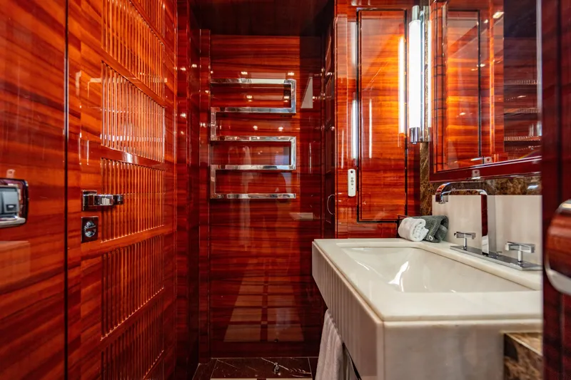 Allora Yacht Photos Pics Luxurious bathroom interior on 2011 Benetti Classic 121 yacht, featuring rich wood paneling and modern fixtures.