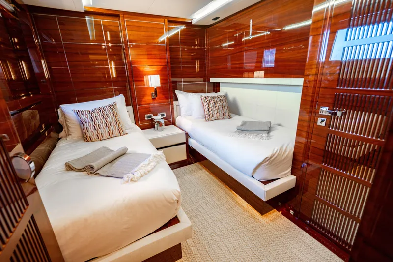 Allora Yacht Photos Pics Luxurious twin cabin interior on 2011 Benetti Classic 121 yacht, featuring elegant wood paneling.
