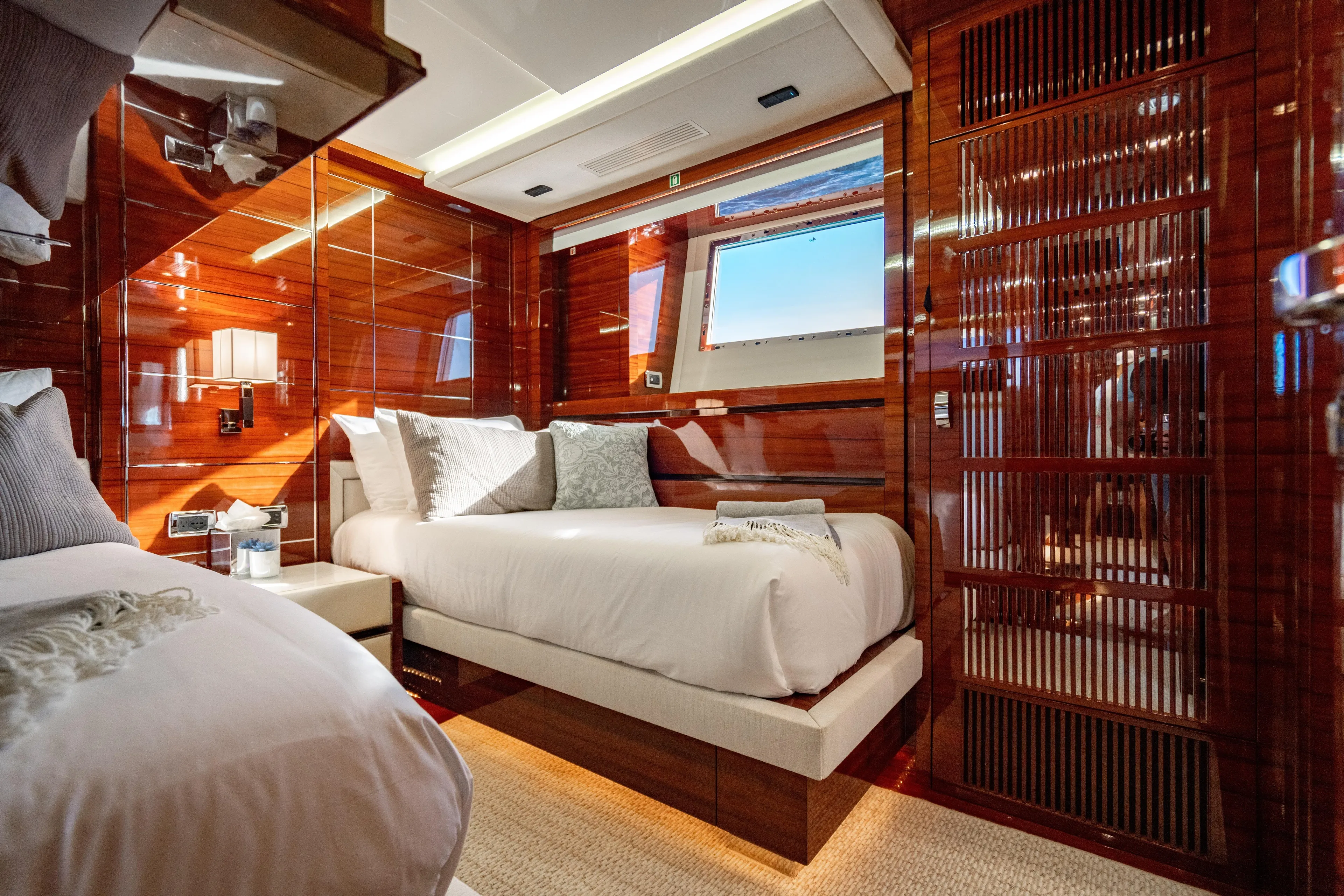 Allora Yacht Photos Pics Luxurious Benetti Classic 121 yacht bedroom, 2011 model, featuring elegant wood paneling and plush bedding.