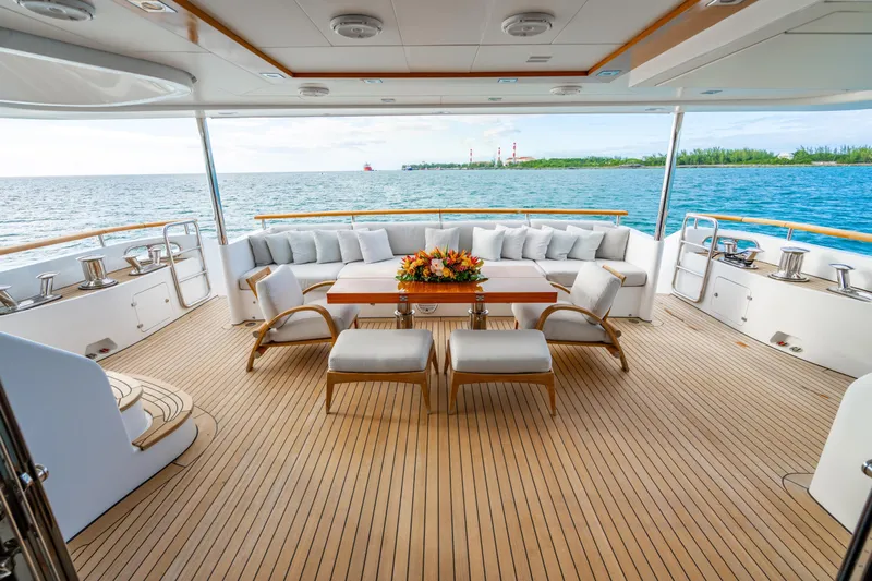 Allora Yacht Photos Pics Luxurious Benetti Classic 121 yacht deck with elegant seating, ocean view, and wooden flooring, 2011 model.