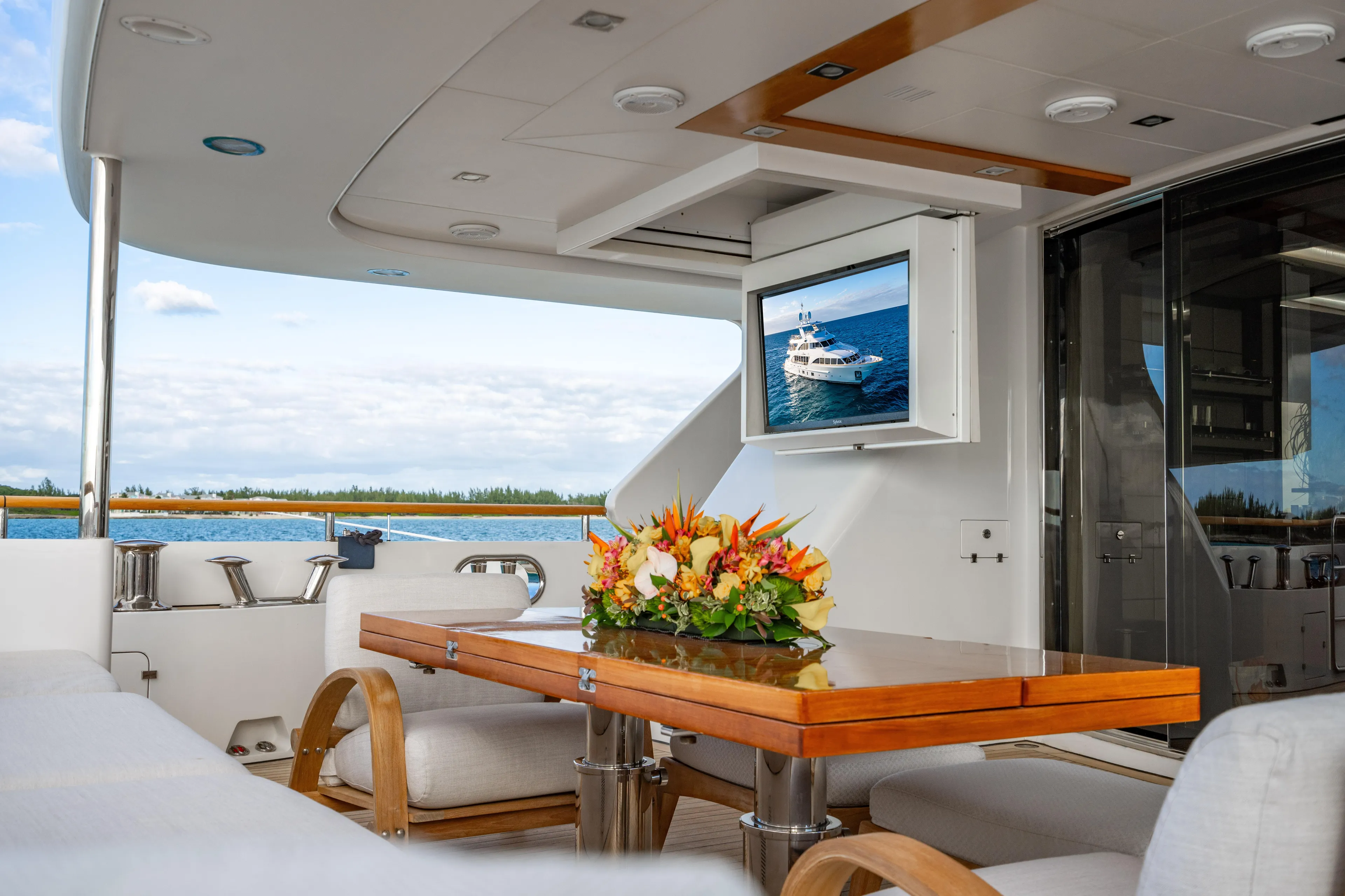 Allora Yacht Photos Pics Luxurious Benetti Classic 121 yacht deck with elegant seating, table, and TV, 2011 model.