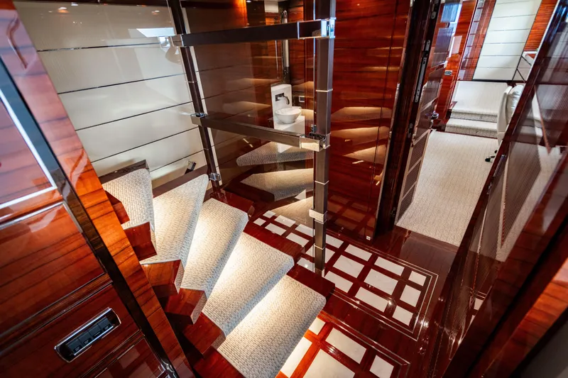Allora Yacht Photos Pics Luxurious interior of 2011 Benetti Classic 121 yacht with elegant wooden staircase.