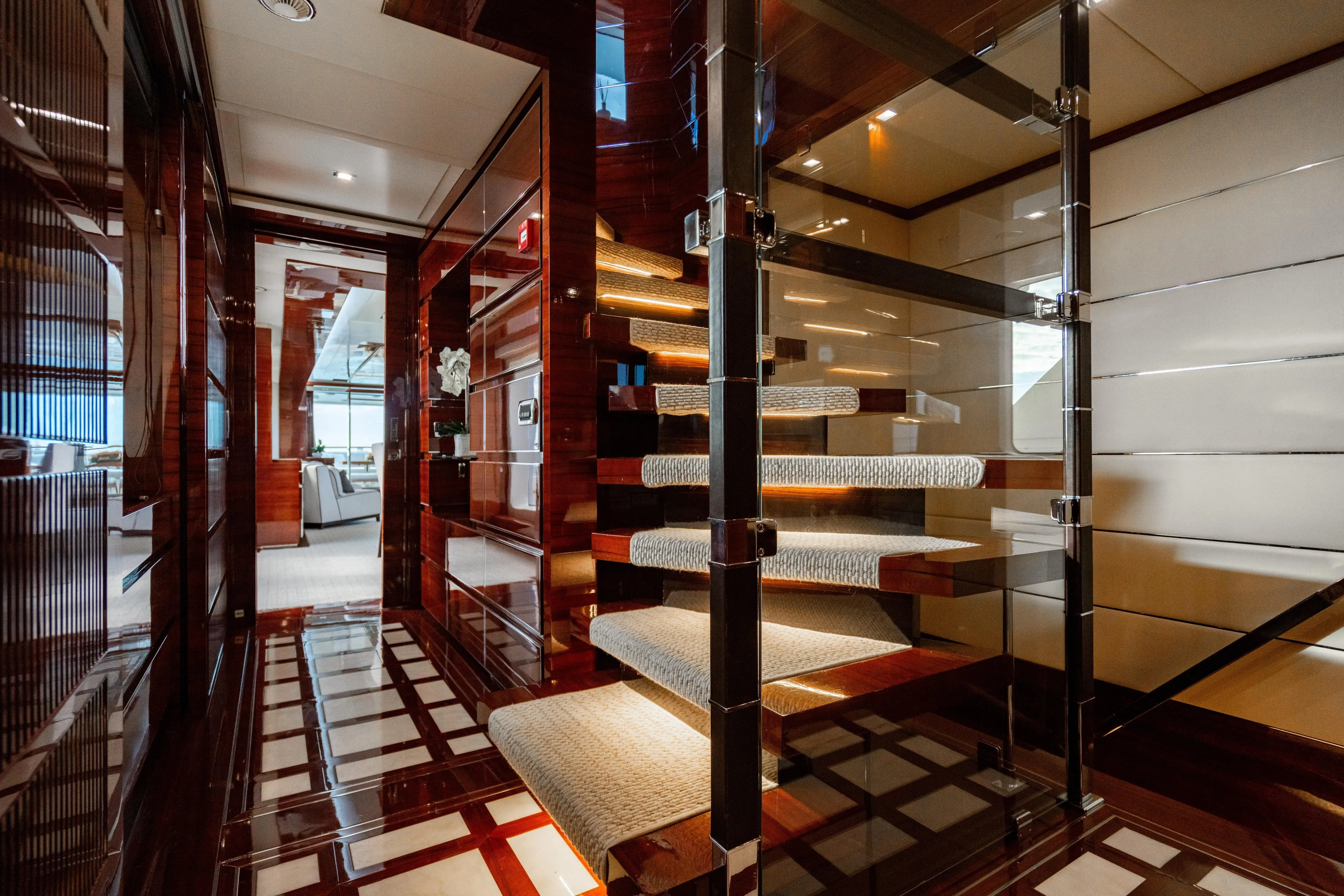 Allora Yacht Photos Pics Luxurious interior of 2011 Benetti Classic 121 yacht with elegant staircase and polished wood finishes.