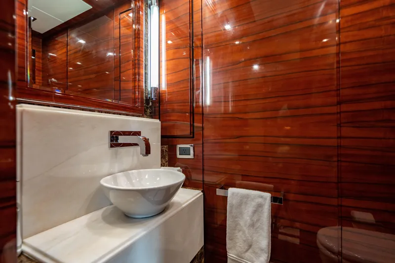 Allora Yacht Photos Pics Luxurious bathroom on 2011 Benetti Classic 121 yacht with elegant wood paneling and modern fixtures.