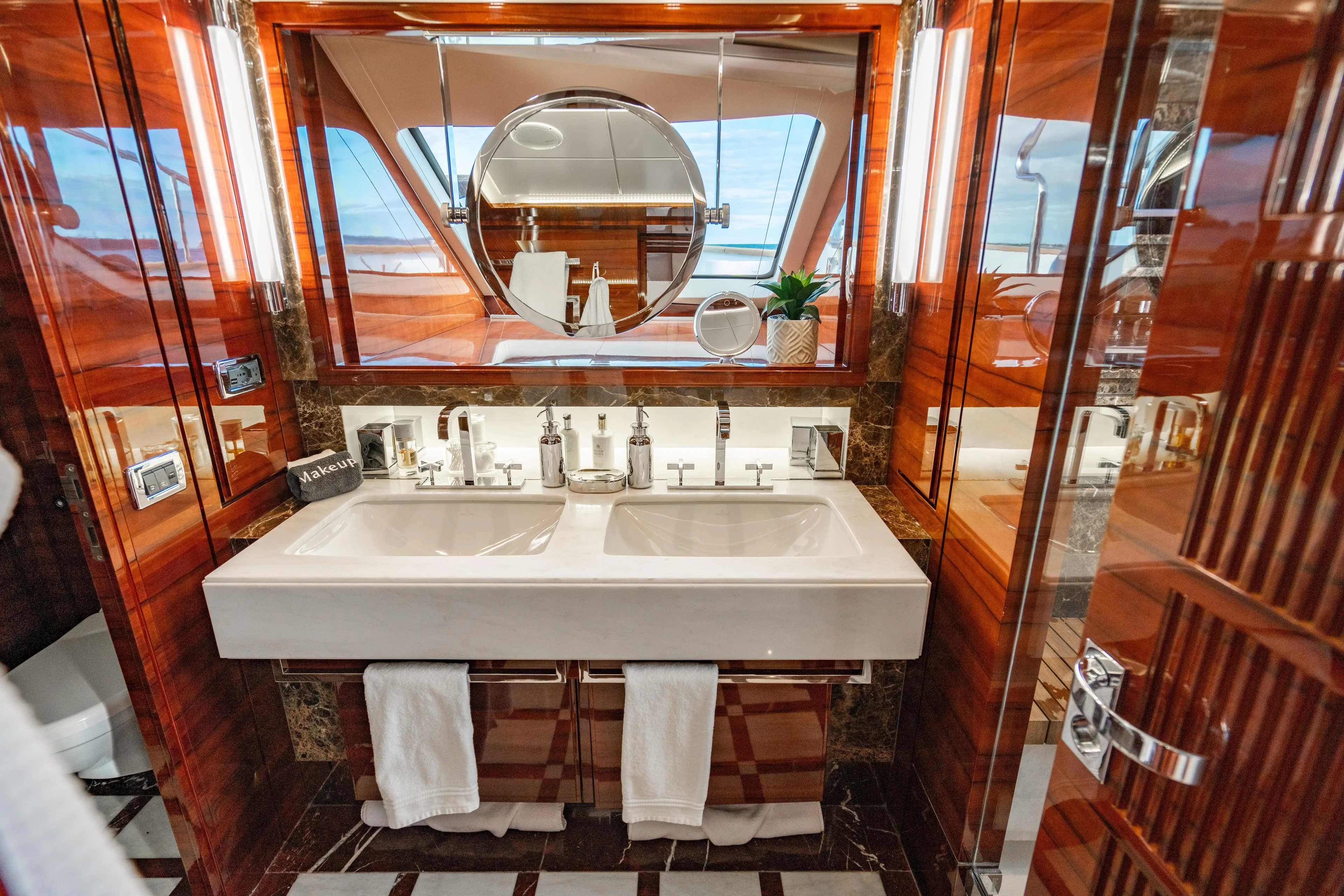 Allora Yacht Photos Pics Luxurious bathroom on 2011 Benetti Classic 121 yacht with double sinks and elegant wood finishes.