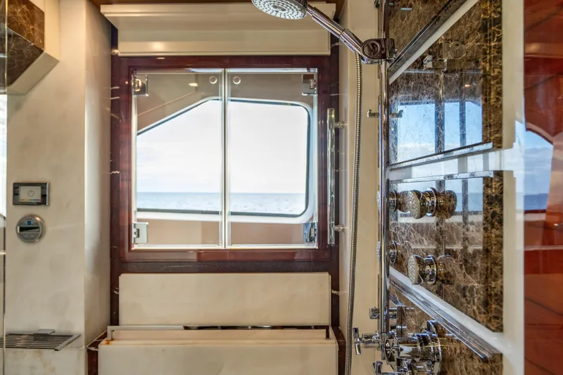 Allora Yacht Photos Pics Luxurious bathroom on 2011 Benetti Classic 121 yacht with ocean view and elegant shower fixtures.