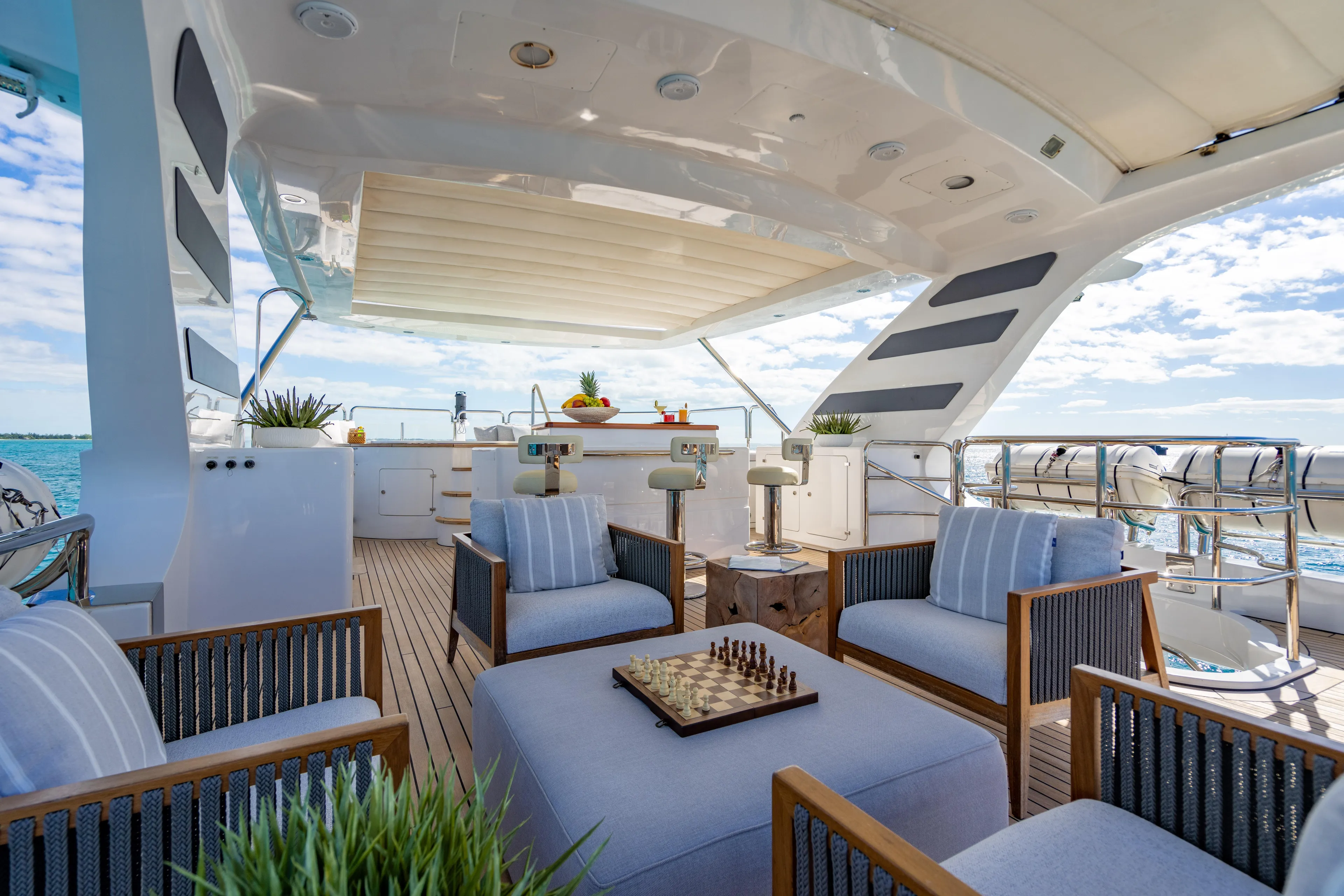 Allora Yacht Photos Pics Luxurious Benetti Classic 121 yacht deck with seating, chessboard, and ocean view, 2011 model.