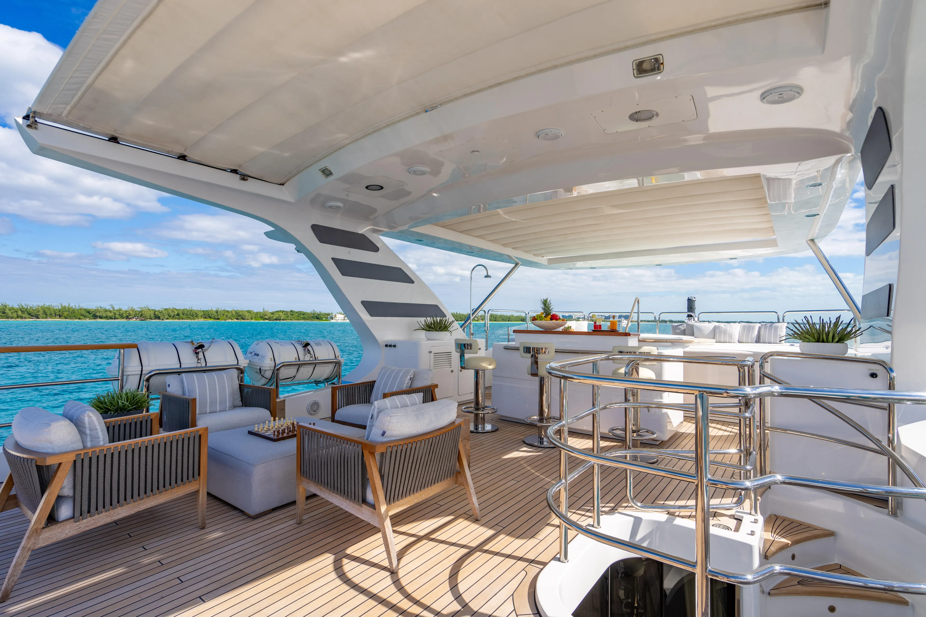 Allora Yacht Photos Pics Luxurious deck of 2011 Benetti Classic 121 yacht with elegant seating and ocean view.