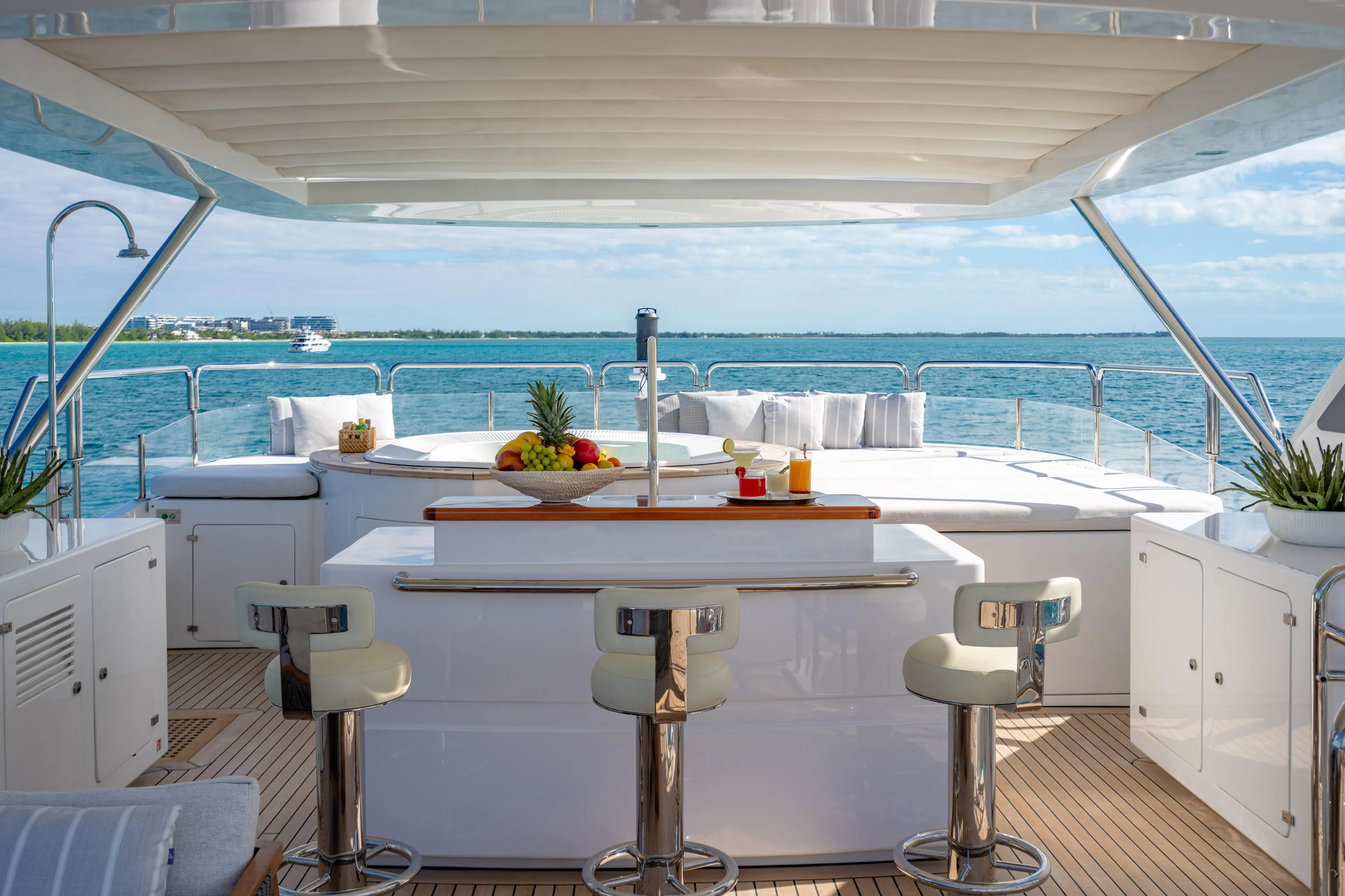 Allora Yacht Photos Pics Luxurious Benetti Classic 121 yacht deck with bar, seating, and ocean view, 2011 model.