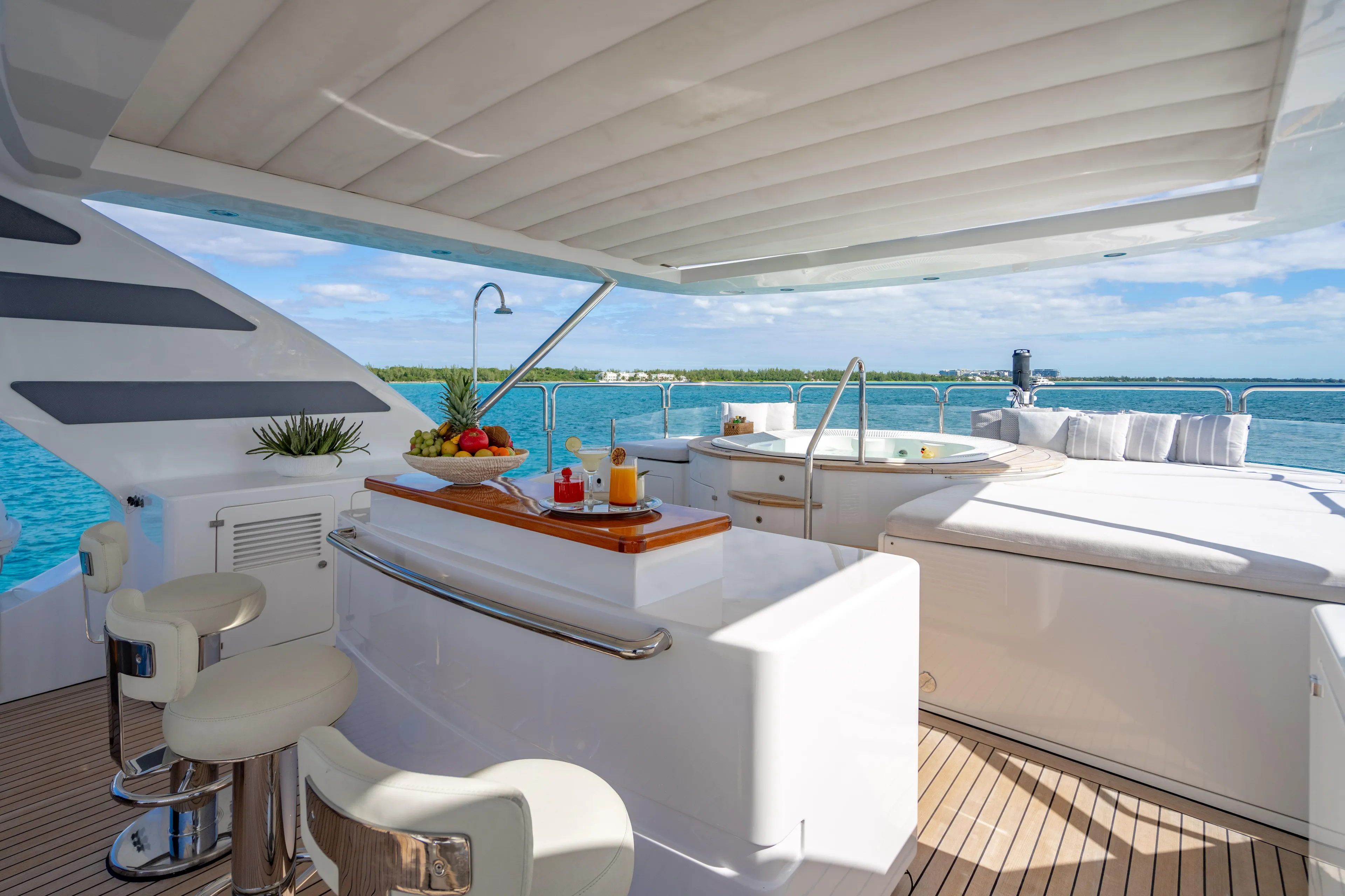 Allora Yacht Photos Pics Luxurious 2011 Benetti Classic 121 yacht deck with bar, stools, and jacuzzi overlooking the ocean.