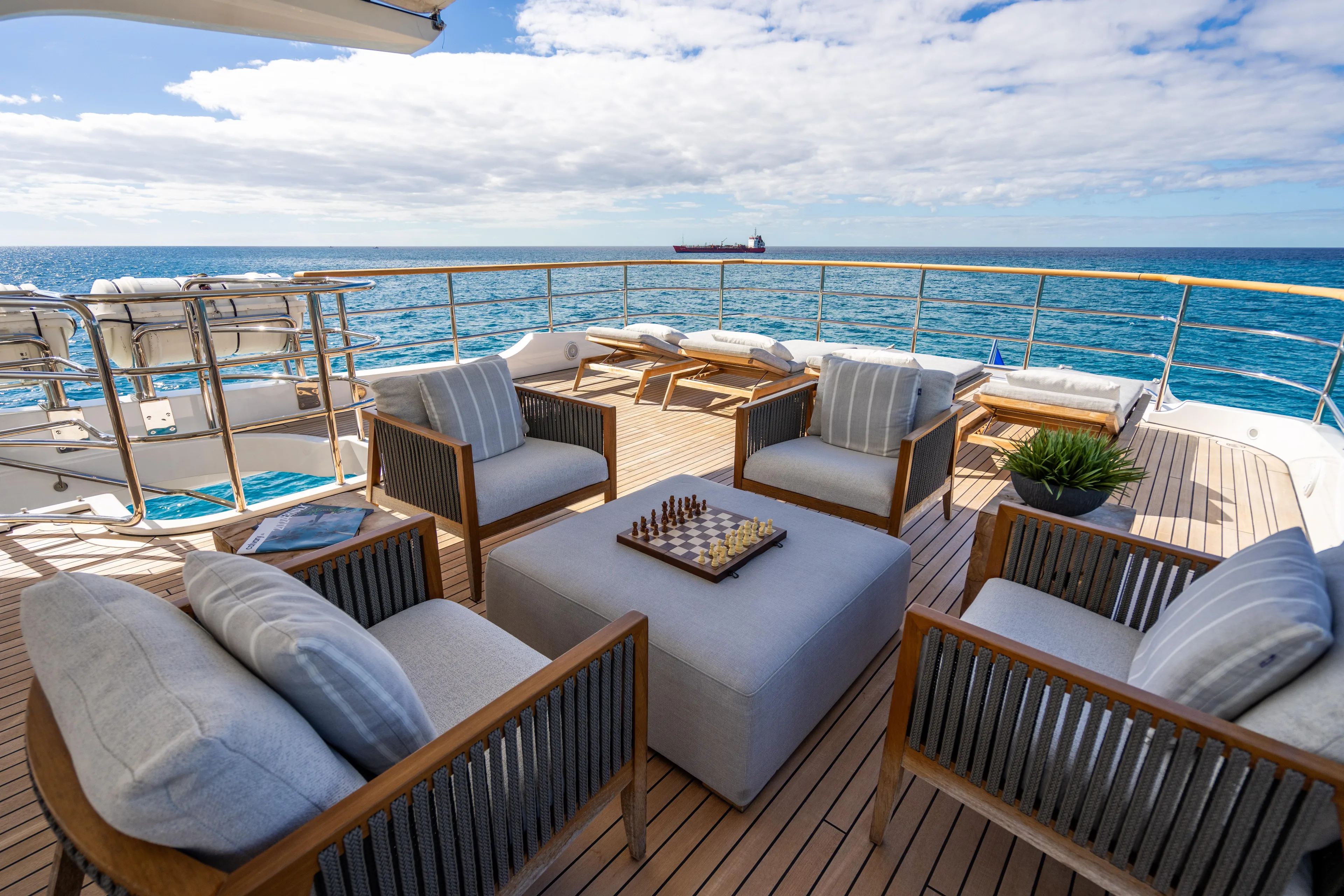 Allora Yacht Photos Pics Luxurious Benetti Classic 121 yacht deck with seating, chessboard, and ocean view, 2011 model.