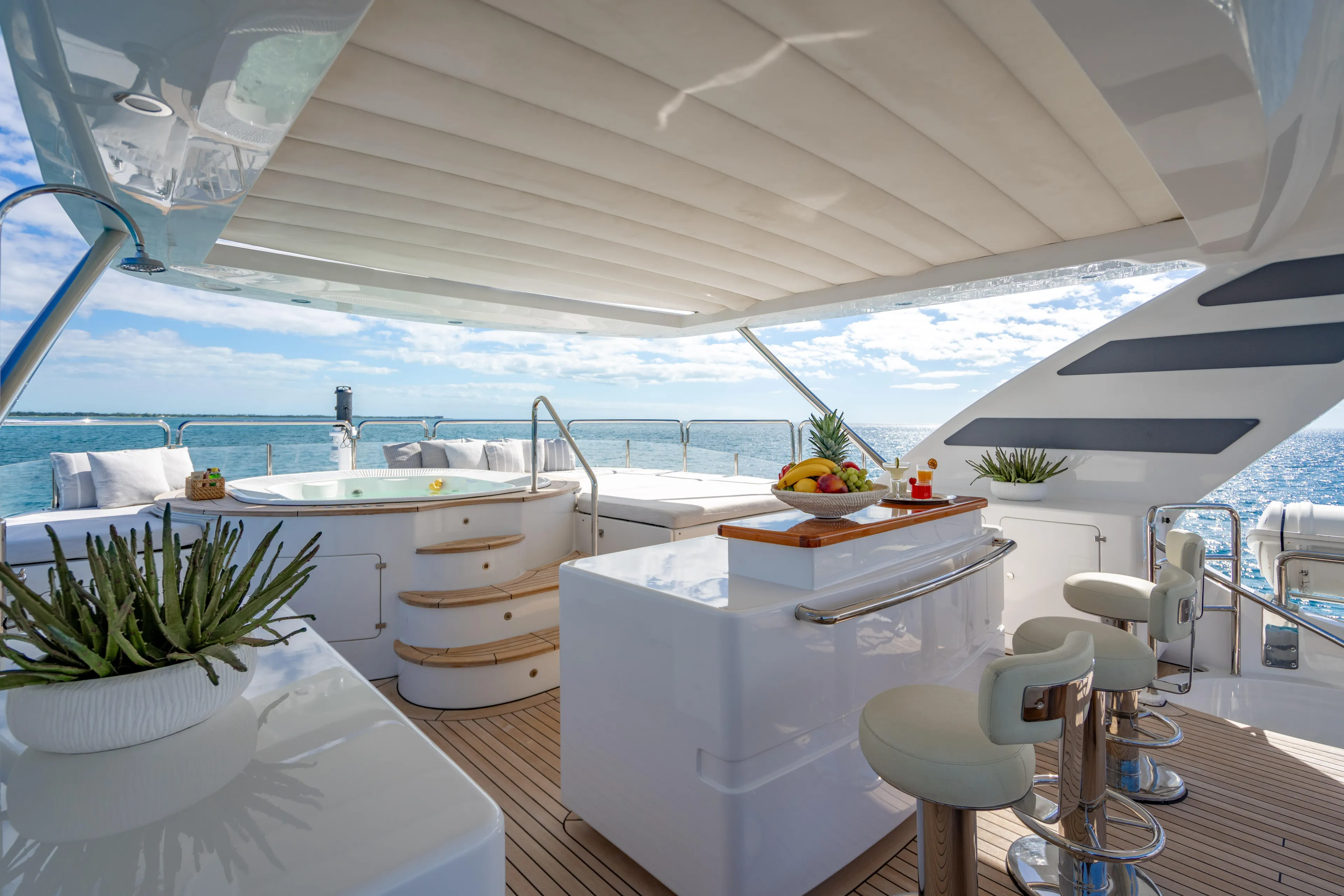 Allora Yacht Photos Pics Luxurious 2011 Benetti Classic 121 yacht deck with jacuzzi and bar, overlooking the ocean.