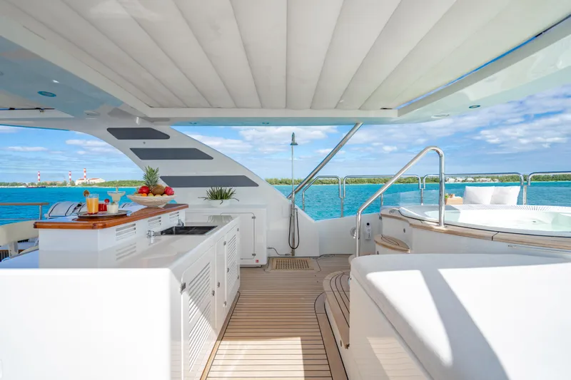 Allora Yacht Photos Pics Luxurious 2011 Benetti Classic 121 yacht deck with bar, seating, and ocean view.