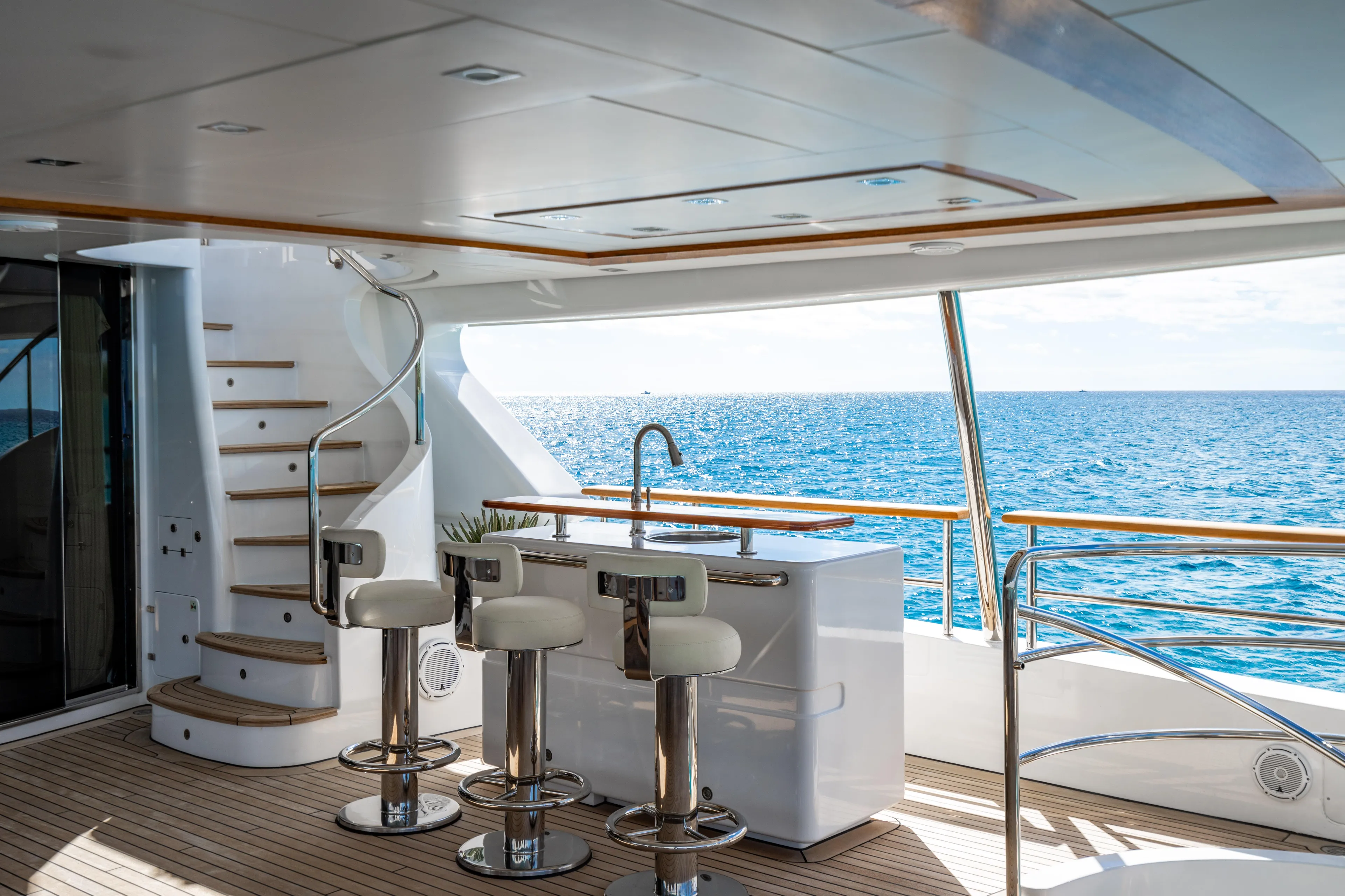 Allora Yacht Photos Pics Luxurious Benetti Classic 121 yacht deck with bar stools, ocean view, and elegant design, 2011 model.