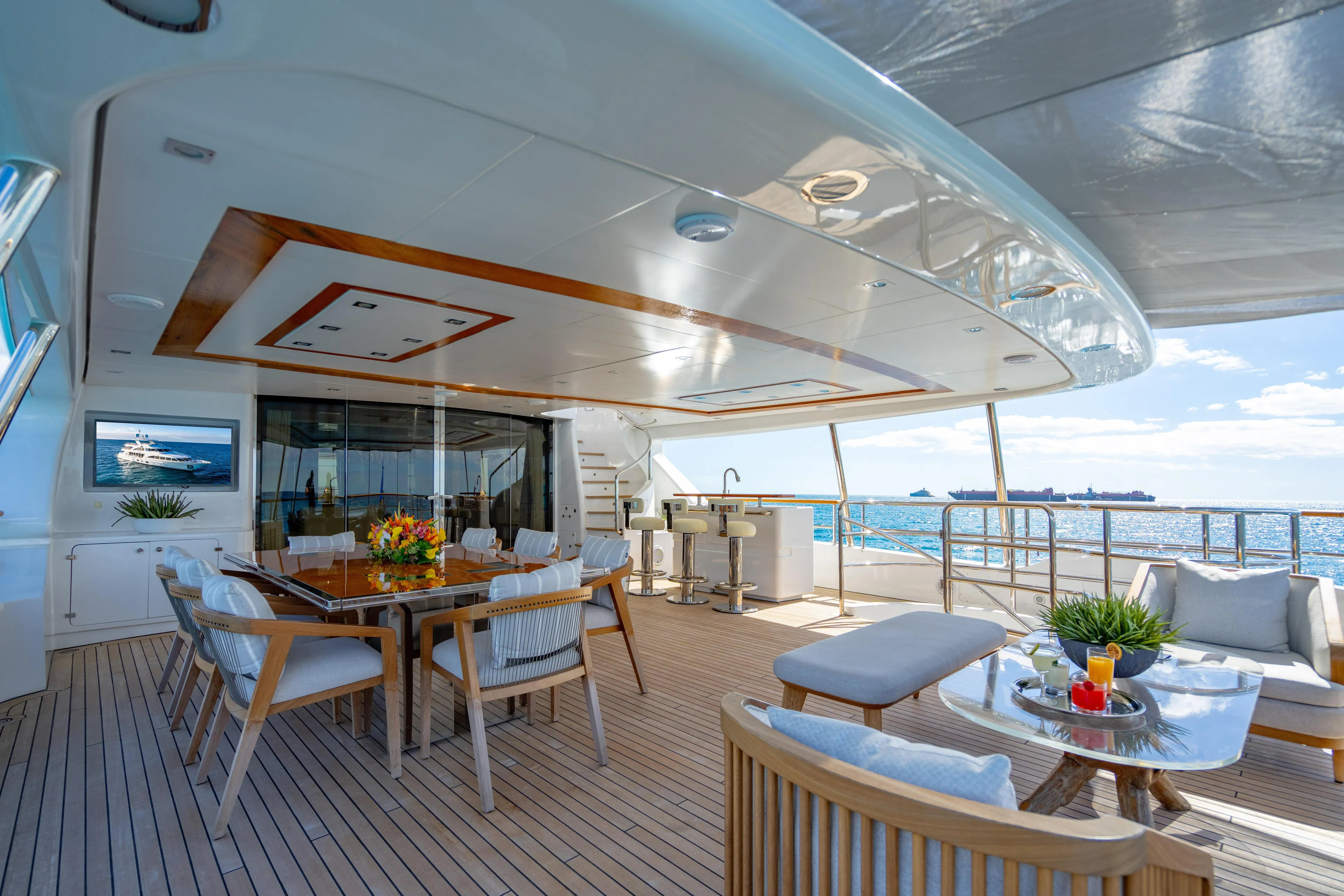 Allora Yacht Photos Pics Luxurious 2011 Benetti Classic 121 yacht deck with elegant dining area and ocean view.
