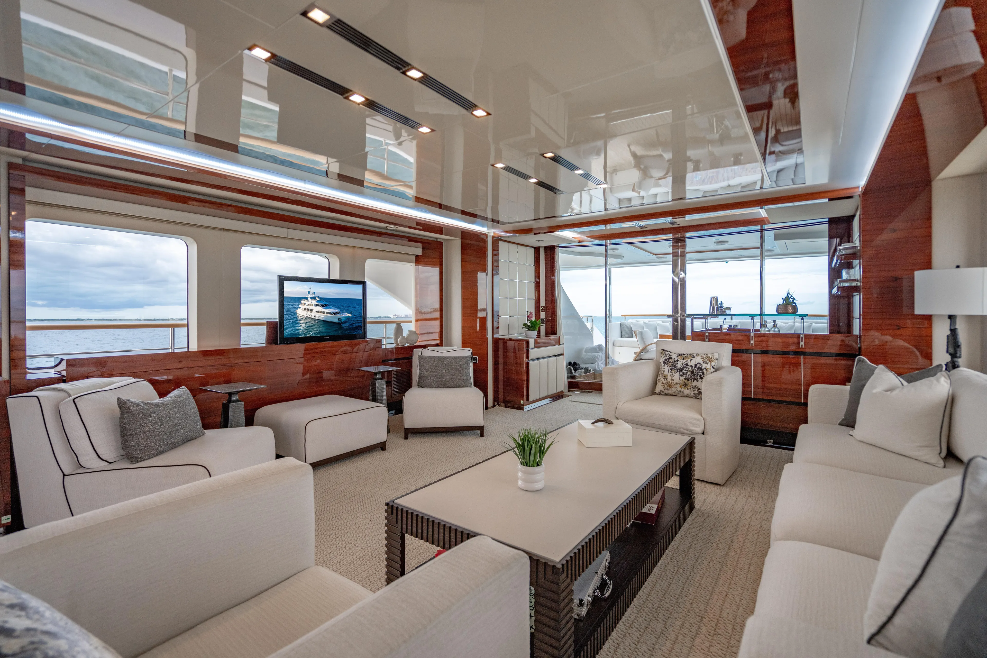 Allora Yacht Photos Pics Luxurious interior of 2011 Benetti Classic 121 yacht with elegant seating and ocean view.