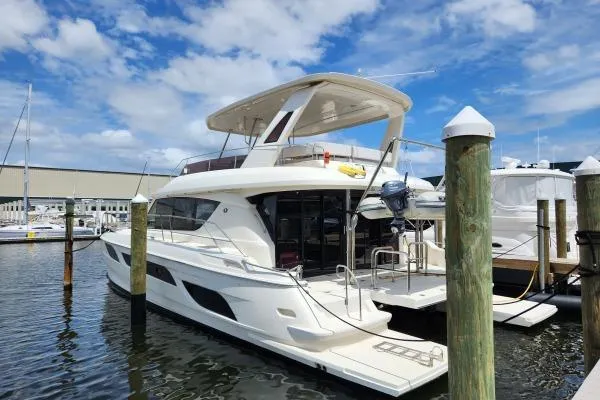 Kimberly Dawn Yacht Photos Pics 2014 Aquila 48 PC yacht docked at marina under blue sky.