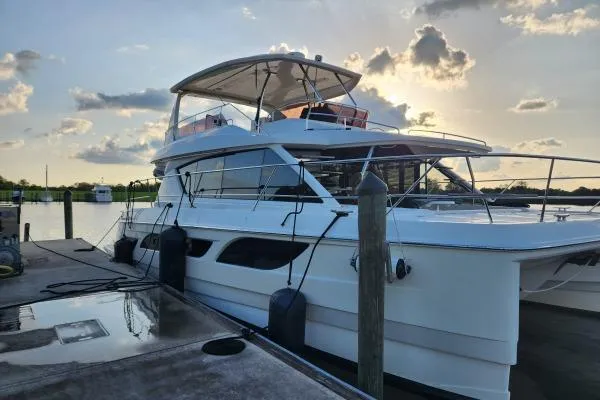Kimberly Dawn Yacht Photos Pics Aquila 48 PC 2014 yacht docked at sunset with scenic sky backdrop.