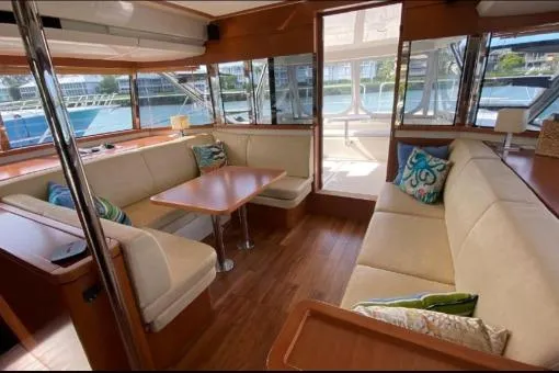 Kimberly Dawn Yacht Photos Pics Luxurious interior of 2014 Aquila 48 PC yacht with elegant seating and wooden finishes.