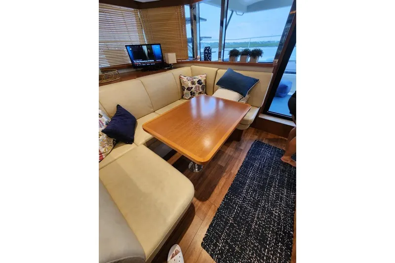Kimberly Dawn Yacht Photos Pics Luxurious interior of 2014 Aquila 48 PC yacht with cozy seating and elegant decor.
