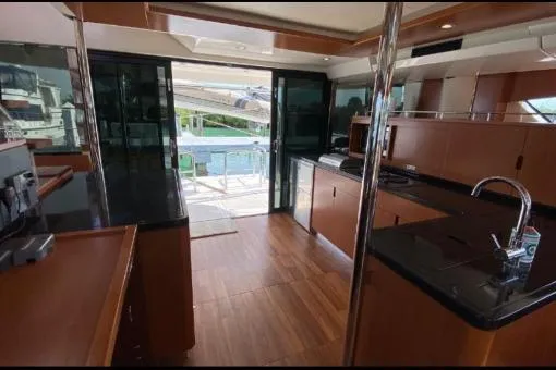 Kimberly Dawn Yacht Photos Pics Interior of 2014 Aquila 48 PC yacht with modern kitchen and sleek wood finishes.