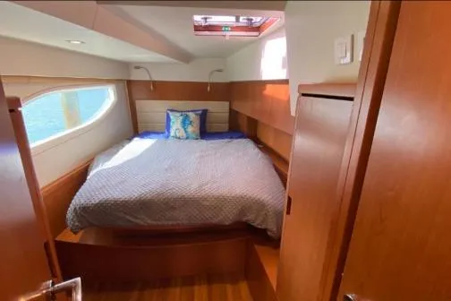 Kimberly Dawn Yacht Photos Pics Cozy bedroom in 2014 Aquila 48 PC yacht with natural light and wooden finishes.