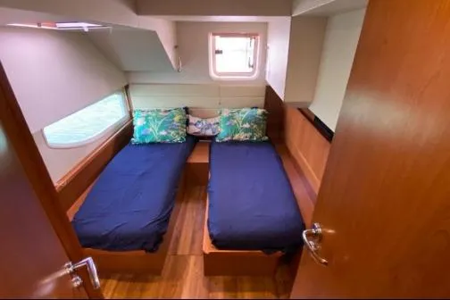 Kimberly Dawn Yacht Photos Pics Interior cabin of 2014 Aquila 48 PC yacht with twin beds and tropical-themed pillows.