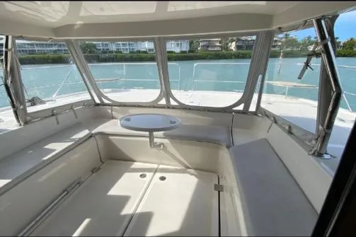 Kimberly Dawn Yacht Photos Pics 2014 Aquila 48 PC yacht interior with seating and table, overlooking serene water.
