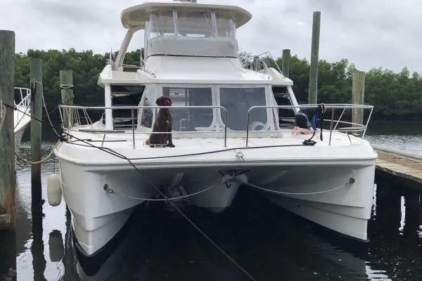 Kimberly Dawn Yacht Photos Pics 2014 Aquila 48 PC catamaran docked, featuring spacious deck and modern design.