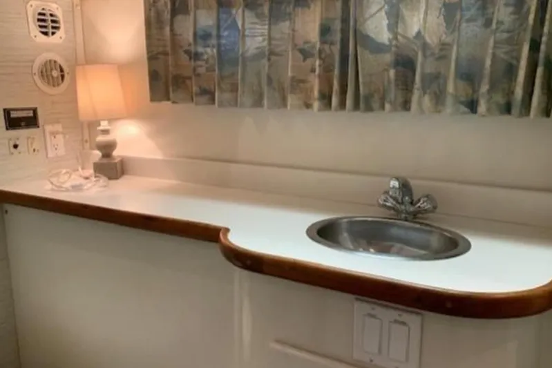  Yacht Photos Pics 1994 Carver 440 Aft Cabin Motor Yacht interior with sink and lamp.