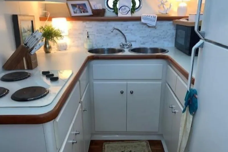  Yacht Photos Pics Compact kitchen in a 1994 Carver 440 Aft Cabin Motor Yacht, featuring modern appliances.