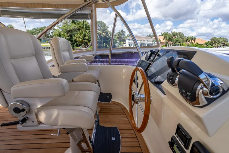 Palm Beach Pb55 Yacht Photos Pics 2019 Palm Beach Motor Yachts PB55 helm with leather seats and wooden steering wheel.