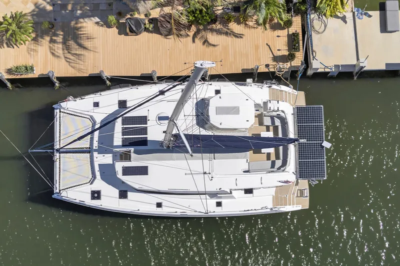  Yacht Photos Pics Aerial view of 2021 Leopard 50 catamaran docked, featuring solar panels and spacious deck.