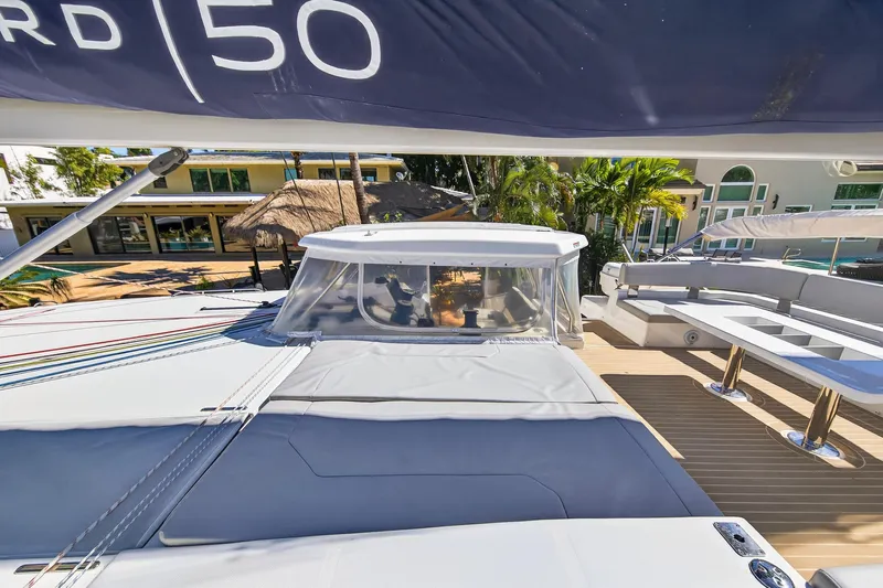  Yacht Photos Pics 2021 Leopard 50 yacht deck with seating and canopy, showcasing luxury and modern design.