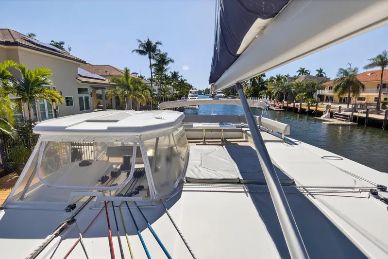  Yacht Photos Pics 2021 Leopard 50 catamaran docked in a sunny waterfront neighborhood.