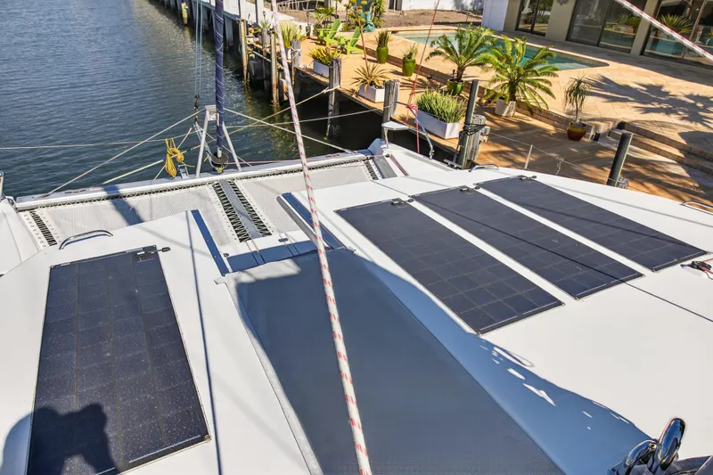 Yacht Photos Pics 2021 Leopard 50 catamaran with solar panels docked by waterfront.