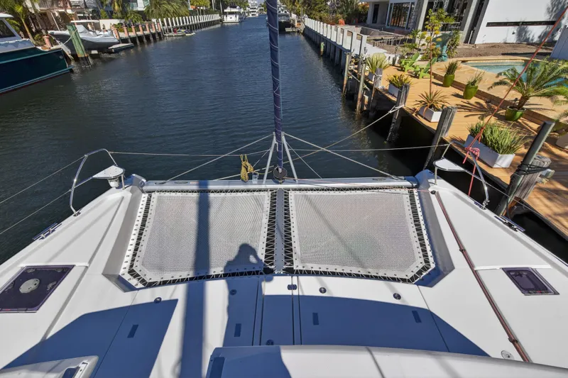  Yacht Photos Pics Catamaran deck view on a 2021 Leopard 50, docked in a scenic canal.