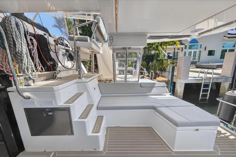  Yacht Photos Pics Luxurious 2021 Leopard 50 yacht deck with seating, ropes, and helm station.
