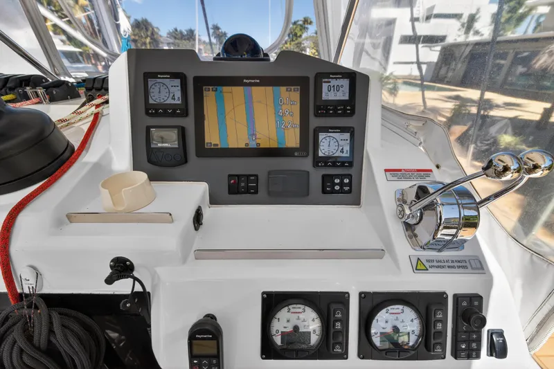  Yacht Photos Pics Control panel of a 2021 Leopard 50 yacht with navigation instruments and throttle levers.